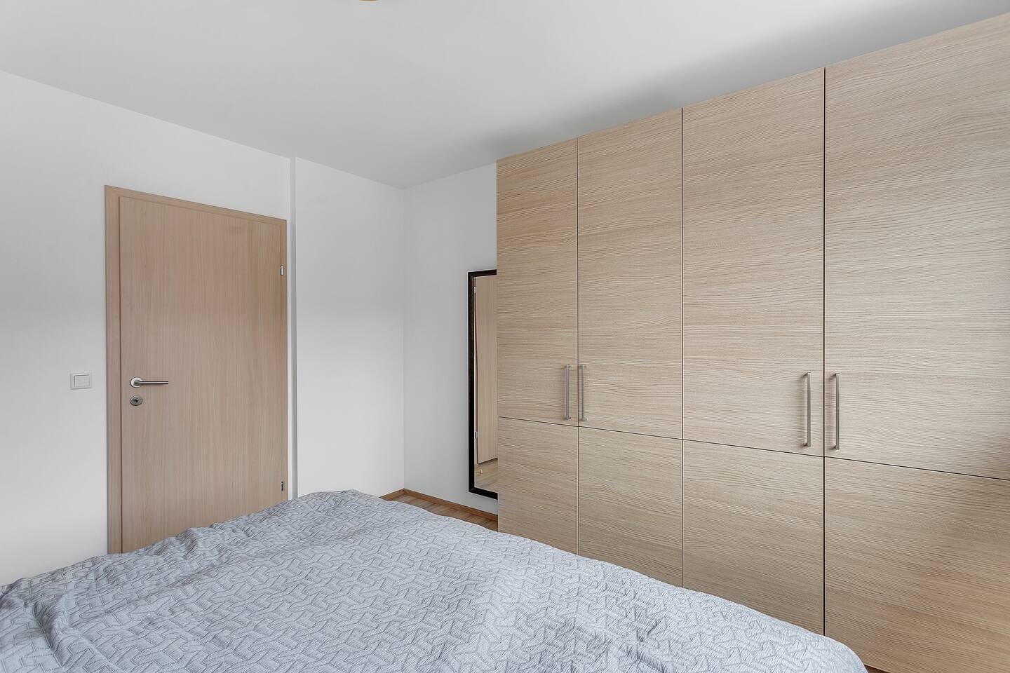 Bedroom with wardrobe and full-length mirror